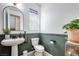 Charming bathroom features stylish pedestal sink, toilet, and decorative plants at 764 Aurora Vale Pl, Henderson, NV 89011