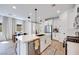 Modern white kitchen featuring an island, stainless steel appliances, and stylish pendant lighting at 764 Aurora Vale Pl, Henderson, NV 89011