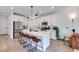 Beautiful kitchen featuring white cabinets, stainless steel appliances, and a large island with barstool seating at 764 Aurora Vale Pl, Henderson, NV 89011