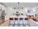 Open-concept kitchen with a large island, modern appliances, and seamless transition to the adjacent living area at 764 Aurora Vale Pl, Henderson, NV 89011