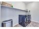 Well-equipped laundry room with modern washer and dryer, and ample shelving at 764 Aurora Vale Pl, Henderson, NV 89011