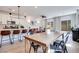 Spacious living area with kitchen view, modern lighting and stylish furnishings at 764 Aurora Vale Pl, Henderson, NV 89011
