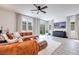 Bright living room with modern furnishings, comfortable seating, and ample natural light from the large windows at 764 Aurora Vale Pl, Henderson, NV 89011