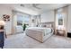 Spacious bedroom with plush carpet, large windows, neutral tones, and a comfortable king-sized bed at 764 Aurora Vale Pl, Henderson, NV 89011