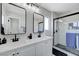 Modern bathroom with double sinks, quartz countertops, and a frameless glass shower at 7726 Keating Cir, Las Vegas, NV 89147