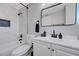 Bathroom with white marble tile, modern black fixtures, and recessed lighting at 7726 Keating Cir, Las Vegas, NV 89147