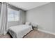 Minimal bedroom with natural light from a large window, and a small mirrored nightstand at 7726 Keating Cir, Las Vegas, NV 89147