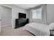 This cozy bedroom features neutral walls, a large window, and comfortable furnishings at 7726 Keating Cir, Las Vegas, NV 89147