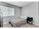 Bedroom with neutral walls, a cozy chair, and a window for natural light at 7726 Keating Cir, Las Vegas, NV 89147