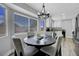 Bright dining area features stylish chandelier and a large window view for a lovely eating experience at 7726 Keating Cir, Las Vegas, NV 89147