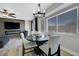 Modern dining area with stylish chandelier and views of backyard pool at 7726 Keating Cir, Las Vegas, NV 89147