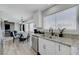 Bright kitchen with granite countertops and stainless steel appliances open to dining area at 7726 Keating Cir, Las Vegas, NV 89147
