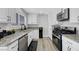 Bright kitchen with white cabinets, granite countertops, and stainless steel appliances at 7726 Keating Cir, Las Vegas, NV 89147