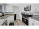 Bright kitchen with white cabinets, granite countertops, and stainless steel appliances at 7726 Keating Cir, Las Vegas, NV 89147