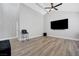 Bright living room with vaulted ceiling, hardwood floors, and large TV at 7726 Keating Cir, Las Vegas, NV 89147
