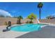 Beautiful backyard pool with slide, basketball hoop and a tall palm tree at 7726 Keating Cir, Las Vegas, NV 89147