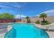 The private pool features a water slide, a basketball hoop, and tropical plants all around at 7726 Keating Cir, Las Vegas, NV 89147