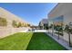 The backyard features a well-manicured lawn, a modern home, and an inviting patio at 787 Willits St, Las Vegas, NV 89138
