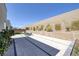 Spacious backyard featuring an expansive patio area, retaining wall landscaping, and comfortable lounge seating at 787 Willits St, Las Vegas, NV 89138