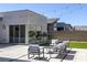 Lush backyard featuring an outdoor lounge space, manicured lawn, and views of the surrounding desert landscape at 787 Willits St, Las Vegas, NV 89138