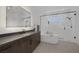 Modern bathroom with a sleek vanity, soaking tub, and a glass-enclosed shower for a spa-like experience at 787 Willits St, Las Vegas, NV 89138