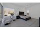 Well-lit main bedroom with stylish decor, large window, and cozy seating area for relaxation at 787 Willits St, Las Vegas, NV 89138