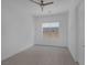 Simple bedroom with neutral paint, with a ceiling fan, window, and tile floor at 787 Willits St, Las Vegas, NV 89138