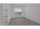 This bedroom features neutral paint, gray tile floor, a window with blinds, and a minimal, modern style at 787 Willits St, Las Vegas, NV 89138