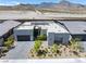 Modern home boasts xeriscaping, grey brick driveway, minimalist aesthetic and a beautiful mountain backdrop at 787 Willits St, Las Vegas, NV 89138