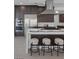 Modern kitchen features stainless appliances, dark wood cabinets, and large center island with seating at 787 Willits St, Las Vegas, NV 89138