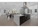 Kitchen showcasing a center island with cooktop, modern lighting, and easy access to dining and living areas at 787 Willits St, Las Vegas, NV 89138