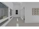 Bright, open living room with tile flooring, white walls, modern artwork, and a large window offering ample natural light at 787 Willits St, Las Vegas, NV 89138