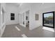 A well lit living room with tile flooring, modern art, and large sliding glass doors to an outdoor patio at 787 Willits St, Las Vegas, NV 89138