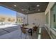 Covered patio with seating and dining area, featuring a ceiling fan and bright natural light at 787 Willits St, Las Vegas, NV 89138