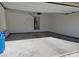An empty two car garage is ready for parking and storage with a utility closet at the back of the space at 806 Star Estates Ave, North Las Vegas, NV 89086