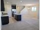 Modern kitchen with stainless steel appliances, granite counters, island, and carpeted living space at 806 Star Estates Ave, North Las Vegas, NV 89086