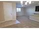 Open-concept living area with neutral walls, carpeted floors, and a modern chandelier at 806 Star Estates Ave, North Las Vegas, NV 89086