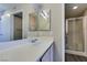 Well-lit bathroom with a shower cabin and ample mirror and sink space at 8070 W Russell Rd # 2121, Las Vegas, NV 89113