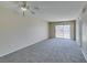Spacious, carpeted bedroom with a ceiling fan and sliding glass door to balcony at 8070 W Russell Rd # 2121, Las Vegas, NV 89113