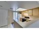 Efficient kitchen with wooden cabinetry, a stovetop, and well-lit work spaces for meal preparation at 8070 W Russell Rd # 2121, Las Vegas, NV 89113