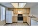 Functional kitchen with appliances and wood cabinets providing efficient storage at 8070 W Russell Rd # 2121, Las Vegas, NV 89113