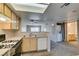 Compact kitchen with a gas range, leading to a combined laundry and bathroom at 8070 W Russell Rd # 2121, Las Vegas, NV 89113