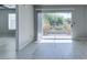 Bright living room featuring wood-look flooring and sliding glass door access to a balcony at 8070 W Russell Rd # 2121, Las Vegas, NV 89113
