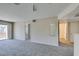 Carpeted living room with a sliding glass door to a balcony and neutral walls at 8070 W Russell Rd # 2121, Las Vegas, NV 89113