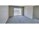Sunny living room with balcony access, plush carpeting, and a ceiling fan at 8070 W Russell Rd # 2121, Las Vegas, NV 89113