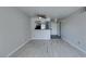 Neutral living room featuring wood-look flooring and a kitchen with black appliances at 8070 W Russell Rd # 2121, Las Vegas, NV 89113