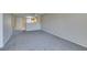 Open-concept living room with plush carpeting and partial view into the kitchen area at 8070 W Russell Rd # 2121, Las Vegas, NV 89113