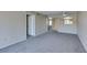 Cozy living room with neutral decor, plush carpeting, and an open doorway to connecting rooms at 8070 W Russell Rd # 2121, Las Vegas, NV 89113