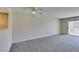 Bright, airy living room with sliding glass doors to a balcony and a ceiling fan at 8070 W Russell Rd # 2121, Las Vegas, NV 89113