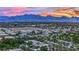 Beautiful aerial view of the city and mountains at sunset, surrounded by homes and desert landscape at 8134 Maddingley Ave, Las Vegas, NV 89117